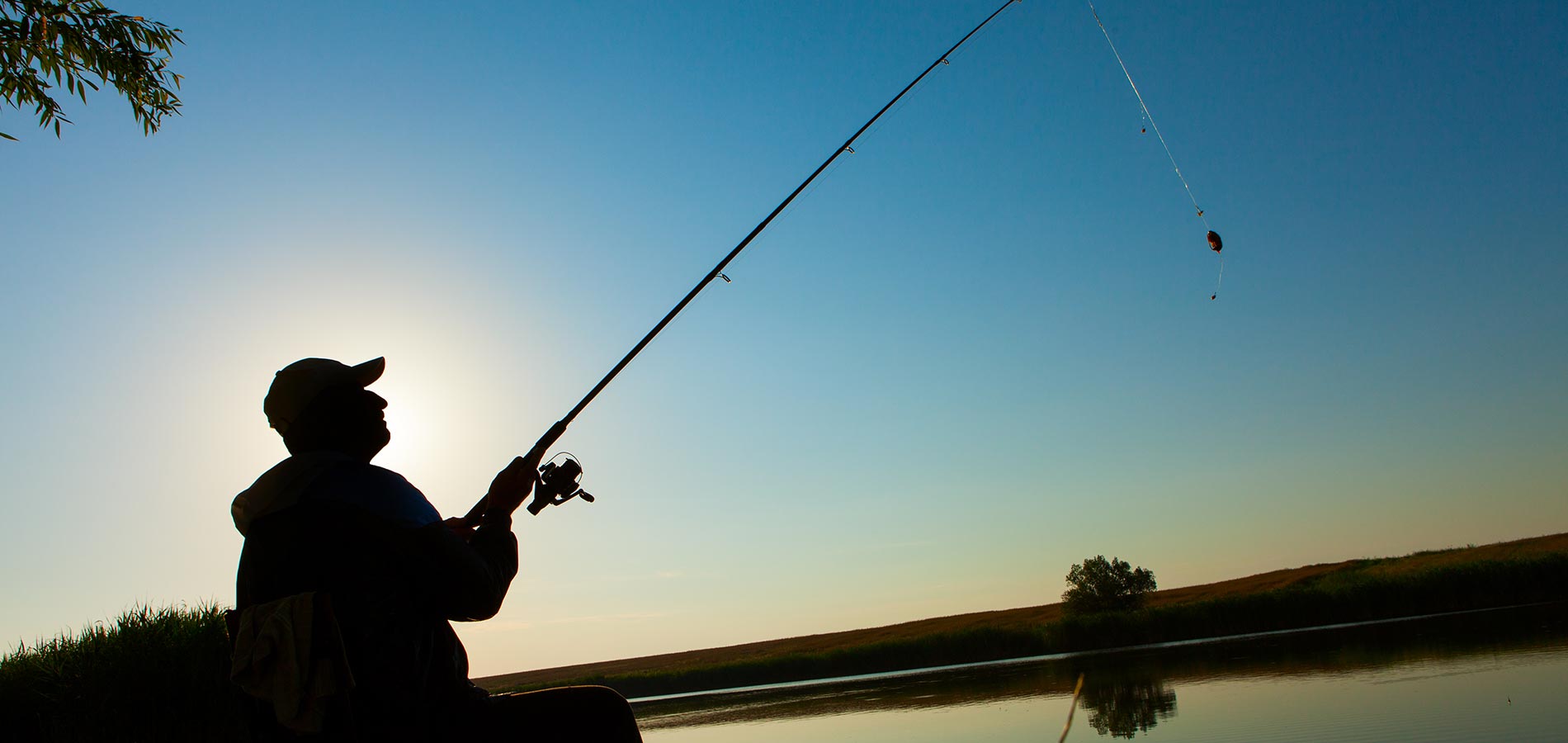 Young man fishing on a lake Young man fishing on a lake