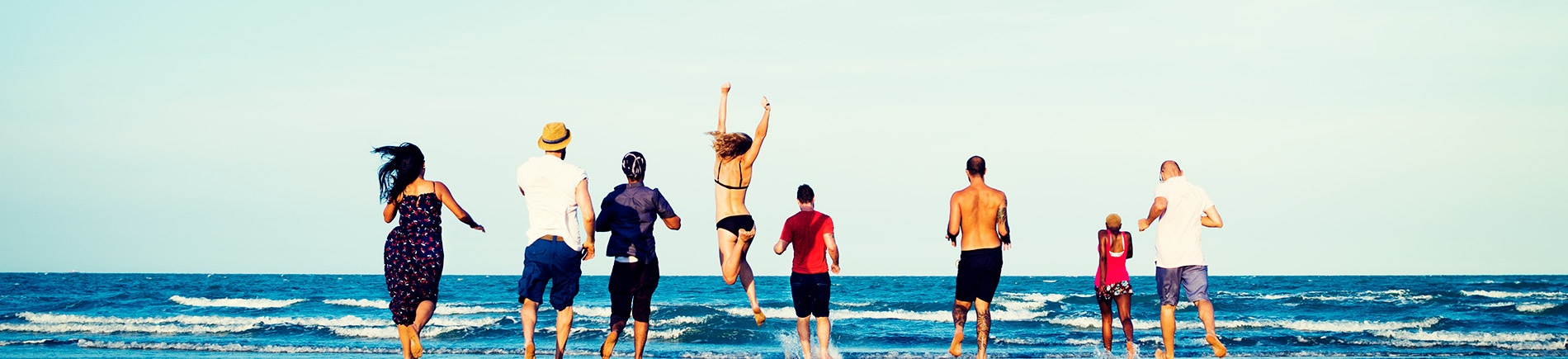 Diverse group of friends running to the beach Diverse group of friends running to the beach